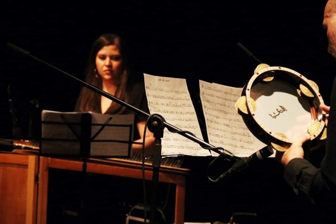 Rula Barghouthi playing the qanun, a traditional West Asian/North African instrument