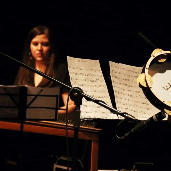 Rula Barghouthi playing the qanun, a traditional West Asian/North African instrument