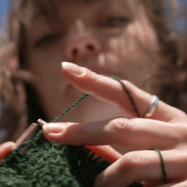 Andrea van der Kuil knitting during her graduation performance. Still from video