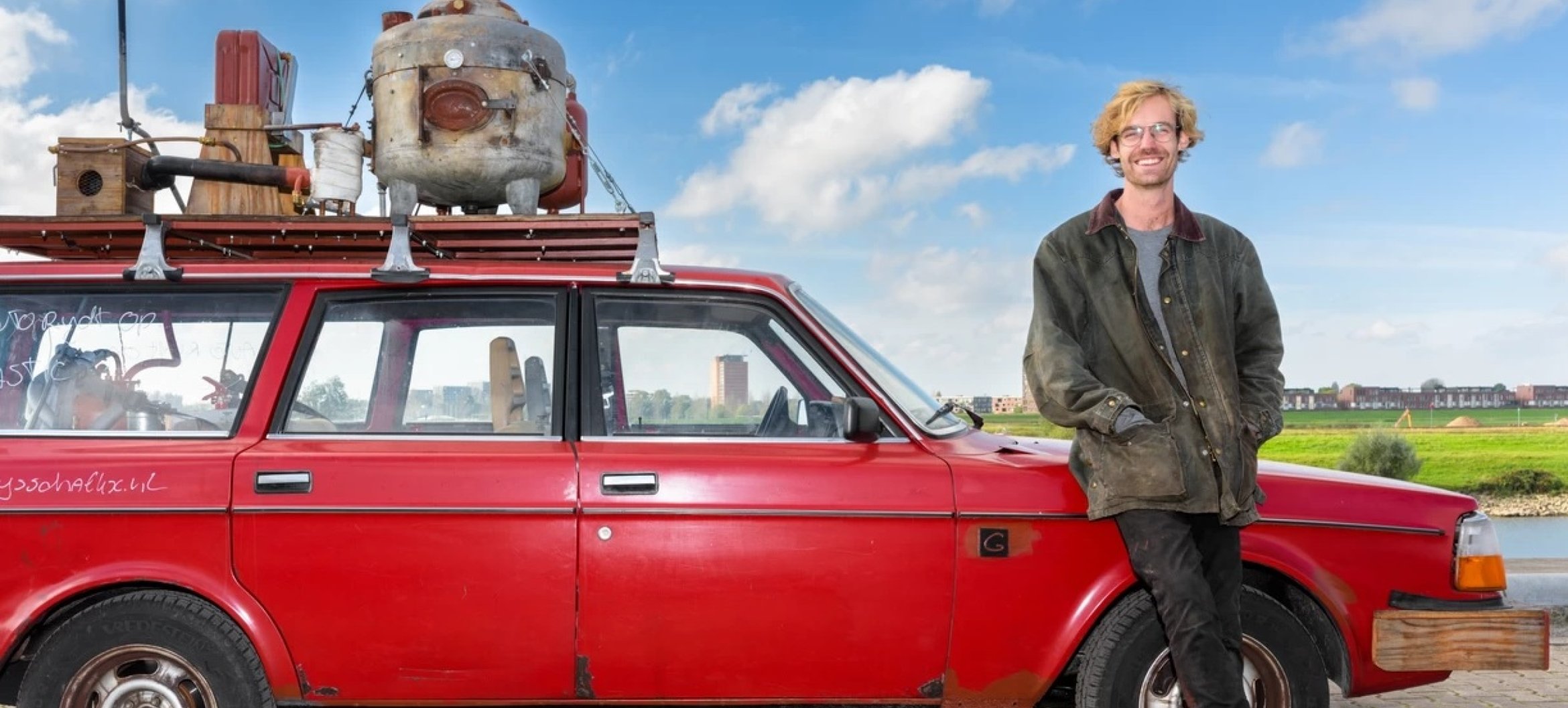 Gijs Schalkx with the car he designed that runs on waste plastic, on display at Dutch Design Week in Eindhoven. Image Sas Schilten, Volkskrant