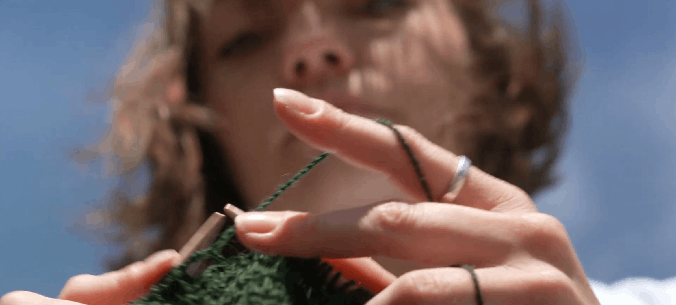 Andrea van der Kuil knitting during her graduation performance. Still from video