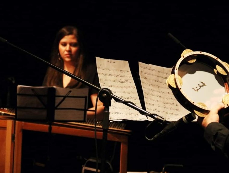 Rula Barghouthi playing the qanun, a traditional West Asian/North African instrument